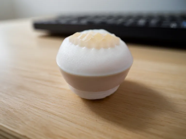 Close-up of a white probiotic lozenge on a desk