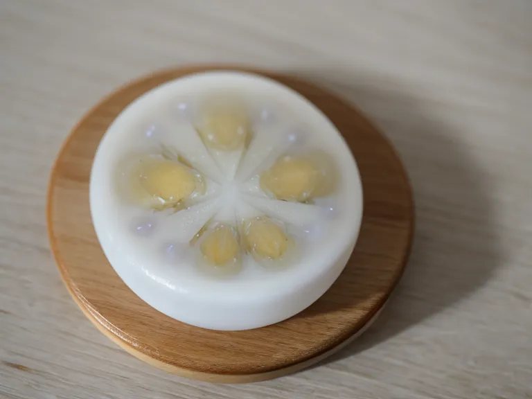 Close-up of an oral probiotic lozenge near a tech worker's laptop.